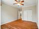 Cozy bedroom with hardwood floors, a ceiling fan, and closet space for storage at 5028 Polo Gate Blvd, Charlotte, NC 28216