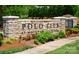 The Polo Club at Mountain Island Lake stone entrance with manicured landscaping and lush green grass at 5028 Polo Gate Blvd, Charlotte, NC 28216