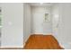 Bright foyer with hardwood floors, white doors, and neutral wall paint at 5028 Polo Gate Blvd, Charlotte, NC 28216