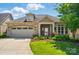 Charming single-Gathering home boasts a stone and siding exterior, well-manicured lawn, and a two-car garage at 5028 Polo Gate Blvd, Charlotte, NC 28216