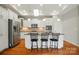 Open kitchen featuring white cabinets, granite countertops, tile backsplash, and a kitchen island with seating at 5028 Polo Gate Blvd, Charlotte, NC 28216