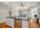 Kitchen island with granite countertop and stainless steel dishwasher with dining space nearby at 5028 Polo Gate Blvd, Charlotte, NC 28216