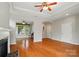 Open living space with hardwood floors, fireplace, and natural light, connecting to the dining area at 5028 Polo Gate Blvd, Charlotte, NC 28216