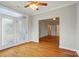Living room featuring hardwood floors, decorative french doors, and an open doorway at 5028 Polo Gate Blvd, Charlotte, NC 28216