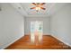 Open living room featuring hardwood floors, neutral walls, and an open doorway at 5028 Polo Gate Blvd, Charlotte, NC 28216