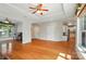 Open living space with hardwood floors, tray ceilings, and natural light, connecting to the kitchen and dining areas at 5028 Polo Gate Blvd, Charlotte, NC 28216