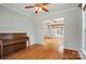 Bright living room featuring hardwood floors, a ceiling fan and natural light from the open doorway at 5028 Polo Gate Blvd, Charlotte, NC 28216