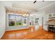Bright living space with large windows, hardwood floors, and a view of the exterior greenery at 5028 Polo Gate Blvd, Charlotte, NC 28216