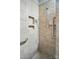 Walk-in shower with tiled walls, built-in niche, and safety grab bar at 5028 Polo Gate Blvd, Charlotte, NC 28216