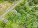 Aerial shot displays a home with inviting pool, RV parking, and vast land at 5240 Old Monroe Rd, Indian Trail, NC 28079