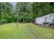 Expansive backyard view with various outdoor equipment, sheds, and greenery, offering ample space for recreation at 5240 Old Monroe Rd, Indian Trail, NC 28079
