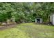 Multiple storage sheds and outbuildings with ample space and green vegetation providing a private outdoor area at 5240 Old Monroe Rd, Indian Trail, NC 28079