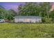 Charming single-story home with a spacious front yard, complemented by mature trees and natural landscaping at 5240 Old Monroe Rd, Indian Trail, NC 28079