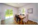 Bright dining area with sliding glass doors to the backyard, wooden table, and laminate floors at 545 Stroupe Rd, Gastonia, NC 28056