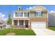 Charming two-story home with a well-manicured lawn, inviting front porch, and a two-car garage at 545 Stroupe Rd, Gastonia, NC 28056