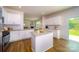 Modern kitchen with stainless appliances and granite island adjoins living room and breakfast nook at 545 Stroupe Rd, Gastonia, NC 28056