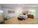 Spacious main bedroom with neutral carpet, a tufted headboard and plenty of natural light at 545 Stroupe Rd, Gastonia, NC 28056