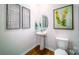 Charming powder room with hardwood floors, pedestal sink, and decorative accents at 545 Stroupe Rd, Gastonia, NC 28056