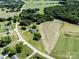 An aerial view of the property, showing the house, ponds, and surrounding landscape at 5710 Lander Benton Rd, Unionville, NC 28110
