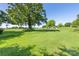 Expansive backyard with mature trees, lush green grass, and plenty of space for outdoor activities at 5710 Lander Benton Rd, Unionville, NC 28110