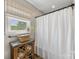 Bathroom showcasing modern shower curtain, window and rustic cabinet at 5710 Lander Benton Rd, Unionville, NC 28110