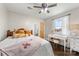 Comfortable bedroom with a decorative bed, desk with vanity and natural light from window at 5710 Lander Benton Rd, Unionville, NC 28110