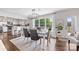 Bright dining area with modern chandelier, hardwood floors and gray chairs with white trim at 5710 Lander Benton Rd, Unionville, NC 28110