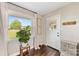 Entryway filled with natural light, potted tree, decor and hardwood floors at 5710 Lander Benton Rd, Unionville, NC 28110