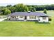 Charming white brick home with a black roof and shutters set on a large lawn at 5710 Lander Benton Rd, Unionville, NC 28110