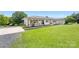 Stylish home featuring a white brick exterior and a lush green front lawn at 5710 Lander Benton Rd, Unionville, NC 28110