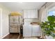 Laundry room with updated washer/dryer, decor cabinet, and hardwood floors at 5710 Lander Benton Rd, Unionville, NC 28110