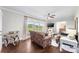 Sun-filled living room with hardwood floors, neutral paint, leather couches and a ceiling fan at 5710 Lander Benton Rd, Unionville, NC 28110