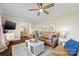 Bright living room with leather couches, ceiling fan, and wooden floors at 5710 Lander Benton Rd, Unionville, NC 28110