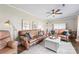Cozy living room featuring two leather couches, ceiling fan and a white coffee table at 5710 Lander Benton Rd, Unionville, NC 28110
