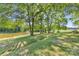 Scenic pond with picnic tables and seating areas under the shade of mature trees at 5710 Lander Benton Rd, Unionville, NC 28110