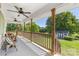 Inviting porch with ceiling fans, bench seating, and a view of the spacious backyard at 5710 Lander Benton Rd, Unionville, NC 28110