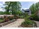 Beautiful backyard with garden, roses, privacy fence, and view of the home's exterior at 5777 Stephanie St, Charlotte, NC 28212