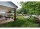 Comfortable covered patio with dining and seating area, plus a hammock in the lovely backyard at 5777 Stephanie St, Charlotte, NC 28212