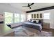 Comfortable bedroom with large windows and a stylish ceiling fan at 5777 Stephanie St, Charlotte, NC 28212