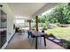 Covered patio with outdoor seating, dining area, and backyard views, perfect for entertaining at 5777 Stephanie St, Charlotte, NC 28212