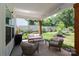 Relaxing covered patio with outdoor seating and views of the lush backyard and garden at 5777 Stephanie St, Charlotte, NC 28212