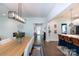 Bright dining room with a modern light fixture, seating for eight, and an open view to the kitchen at 5777 Stephanie St, Charlotte, NC 28212