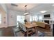 Open floor plan showcases dining area with modern light fixture and seamless transition to the living room with fireplace at 5777 Stephanie St, Charlotte, NC 28212