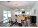 Dining space blending seamlessly into the living area, illuminated by modern lighting with sliding door access at 5777 Stephanie St, Charlotte, NC 28212