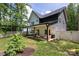 The house’s backyard features a patio, lounge seating, and well-manicured lawn at 5777 Stephanie St, Charlotte, NC 28212