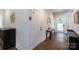 Inviting foyer with sleek design elements and hardwood flooring, offering a glimpse into other living spaces at 5777 Stephanie St, Charlotte, NC 28212