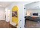 Inviting hallway with hardwood floors and bright living room beyond doorway at 5777 Stephanie St, Charlotte, NC 28212