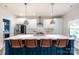 Stylish kitchen with a large island, stainless steel appliances, and white cabinetry, perfect for entertaining at 5777 Stephanie St, Charlotte, NC 28212