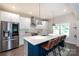 Modern kitchen with stainless steel appliances, a large island, and stylish pendant lighting at 5777 Stephanie St, Charlotte, NC 28212