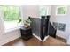 Light-filled landing with black railing, hardwood floors, and green views at 5777 Stephanie St, Charlotte, NC 28212